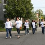 A group of participants, volunteers and staff head out to talk to our neighbours