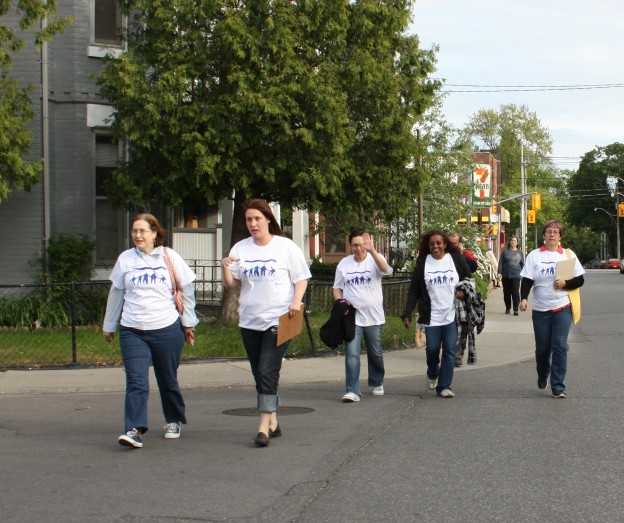 A group of participants, volunteers and staff head out to talk to our neighbours