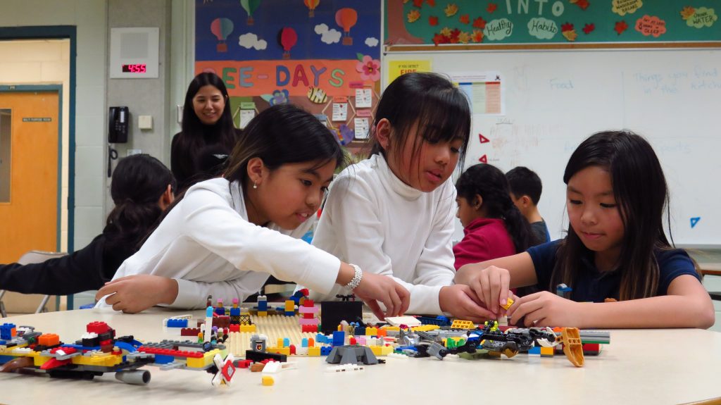 Three girls playing with lego in the After School Program