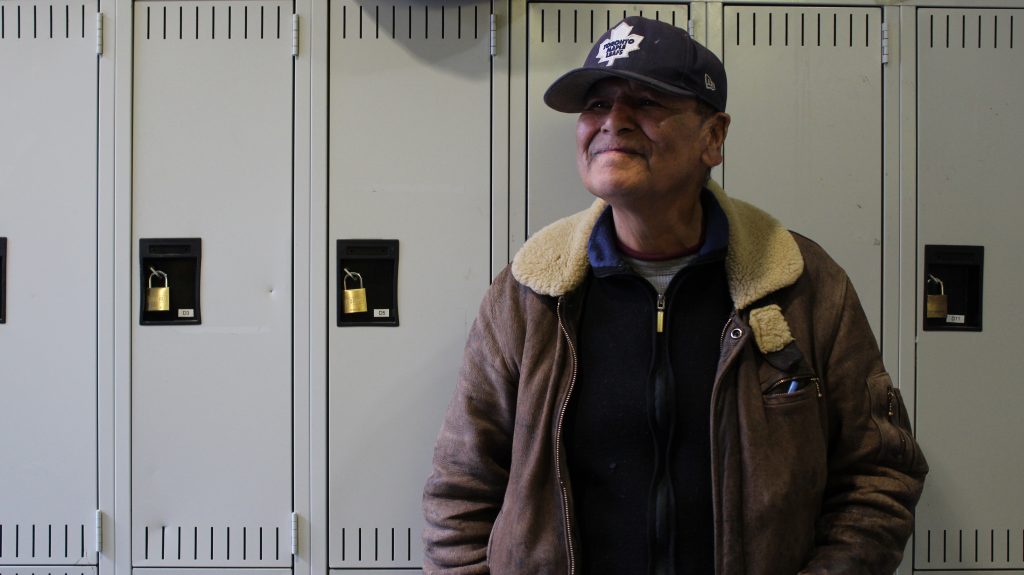 A participant at the Meeting Place stands in front of a row of lockers.