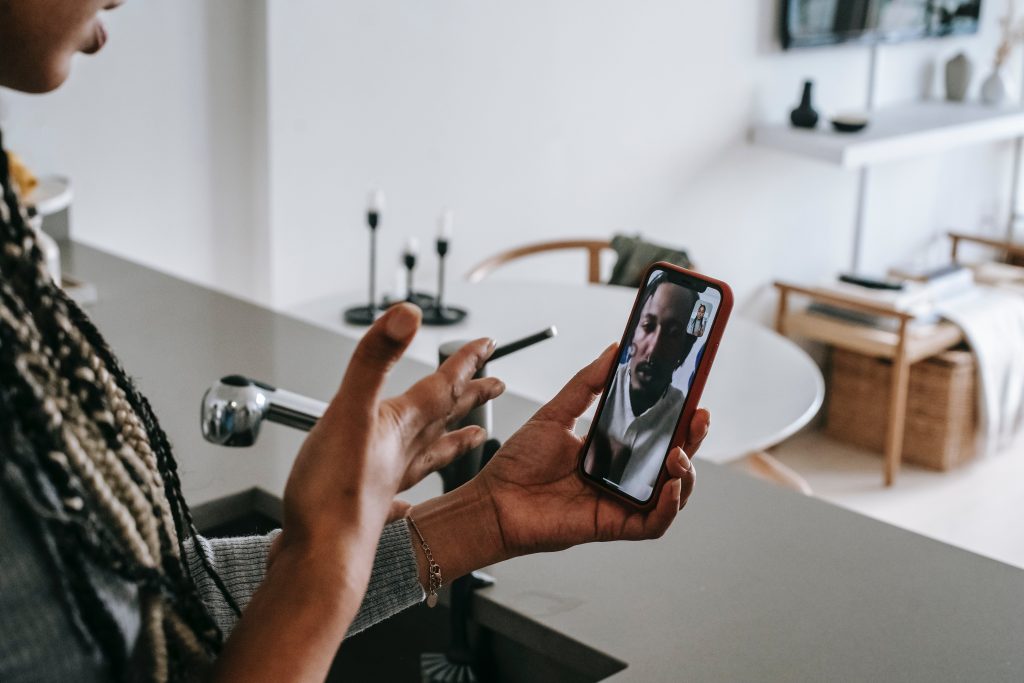 Two people talk over video chat on a phone